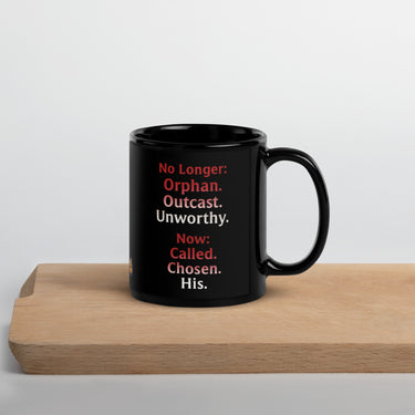 Renamed Black Glossy Mug 11oz reverse side with red fade to white word stack: “No longer: Orphan. Outcast. Unworthy. Now: Chosen. Called. His.”